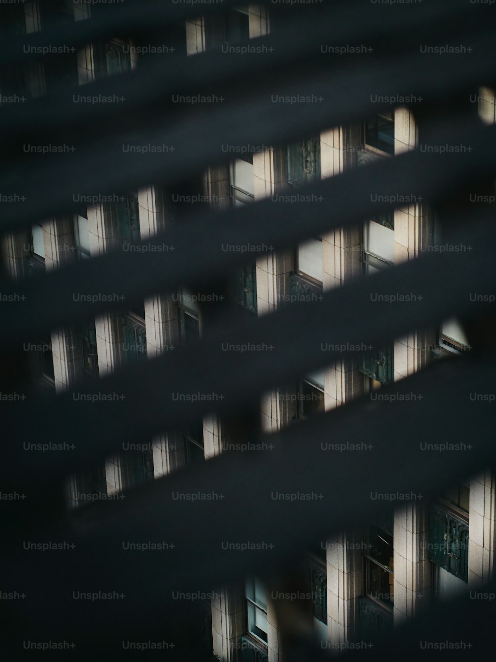 a view of a building through the blinds of a window