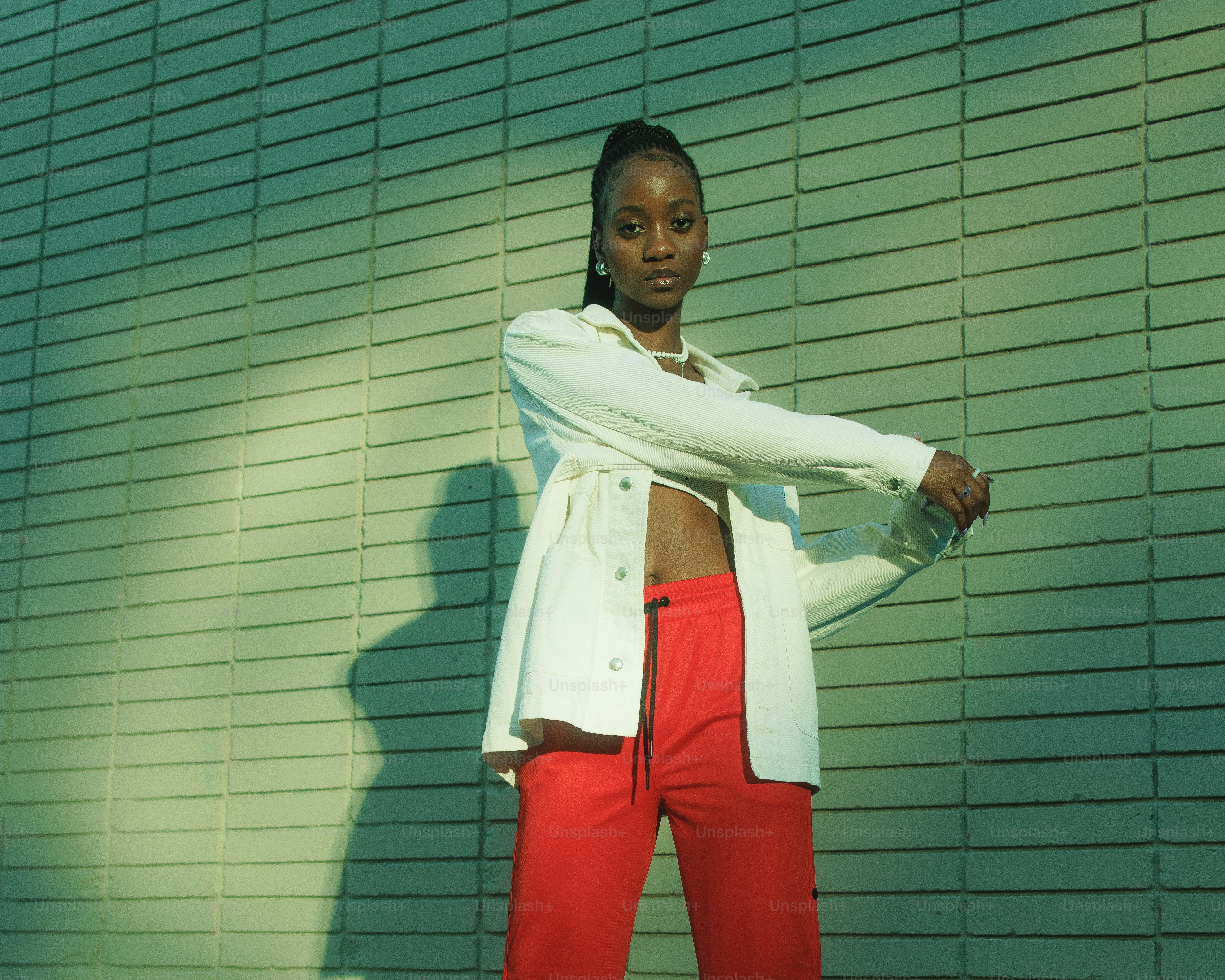 A woman in red pants and a white jacket photo – Fashion Image on Unsplash