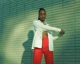 a woman in red pants and a white jacket