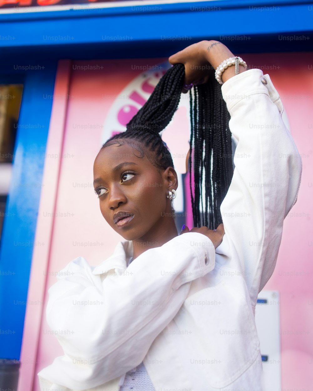 a woman with braids standing in front of a store