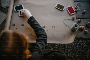 a person sitting at a table with two cell phones