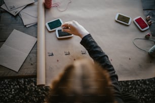 a person holding a smart phone over a table