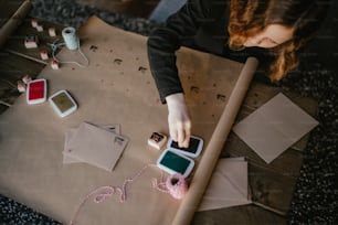 a woman is looking at a piece of paper on a table