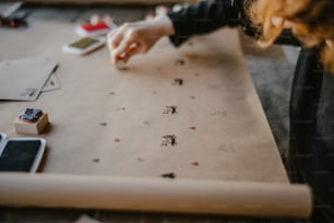 a woman is working on a craft project