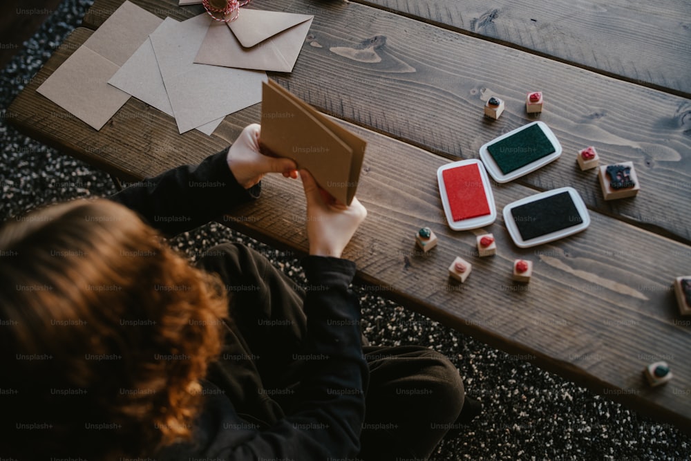 a person sitting at a table holding a box