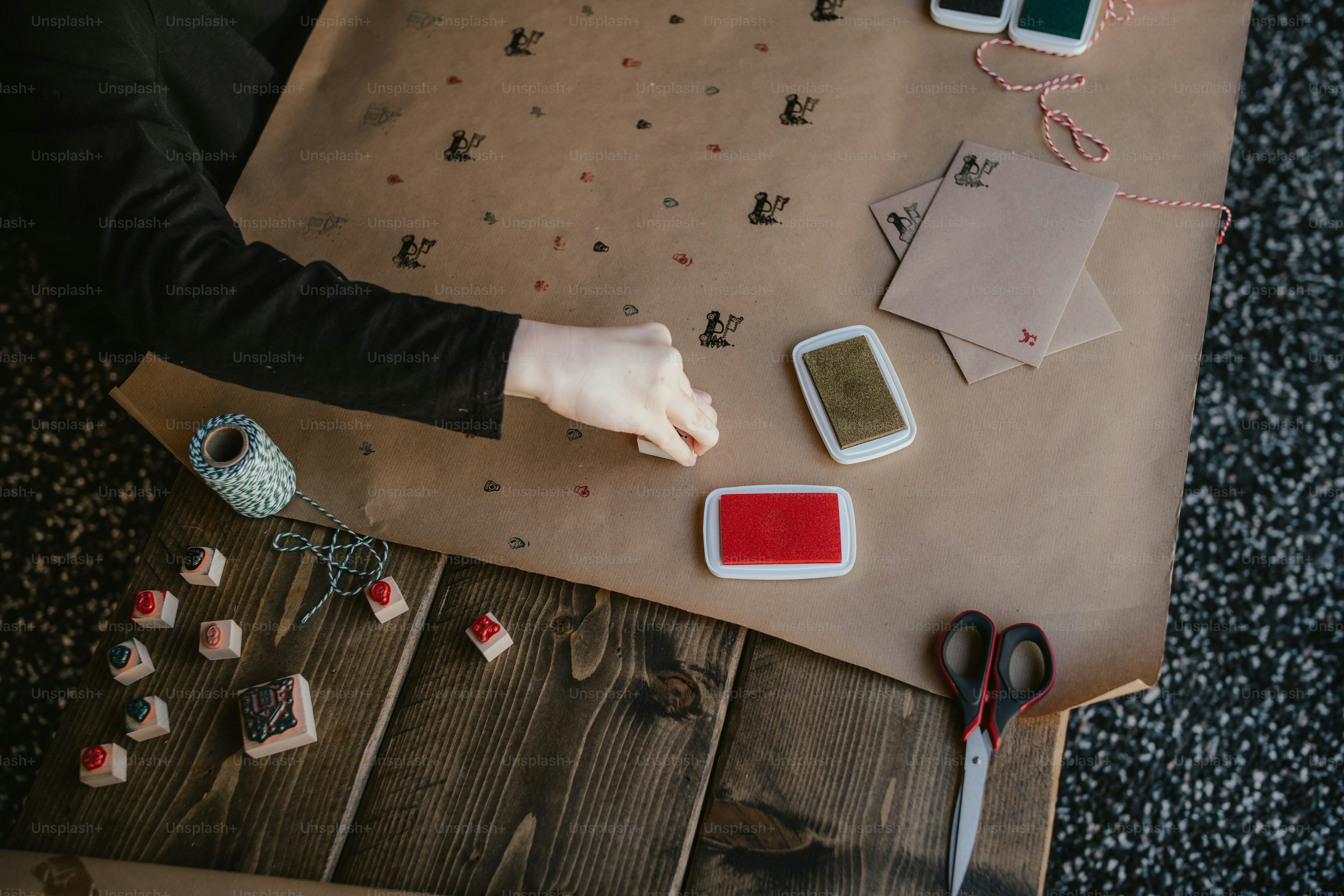 A person is using a pair of scissors on a piece of paper photo ...