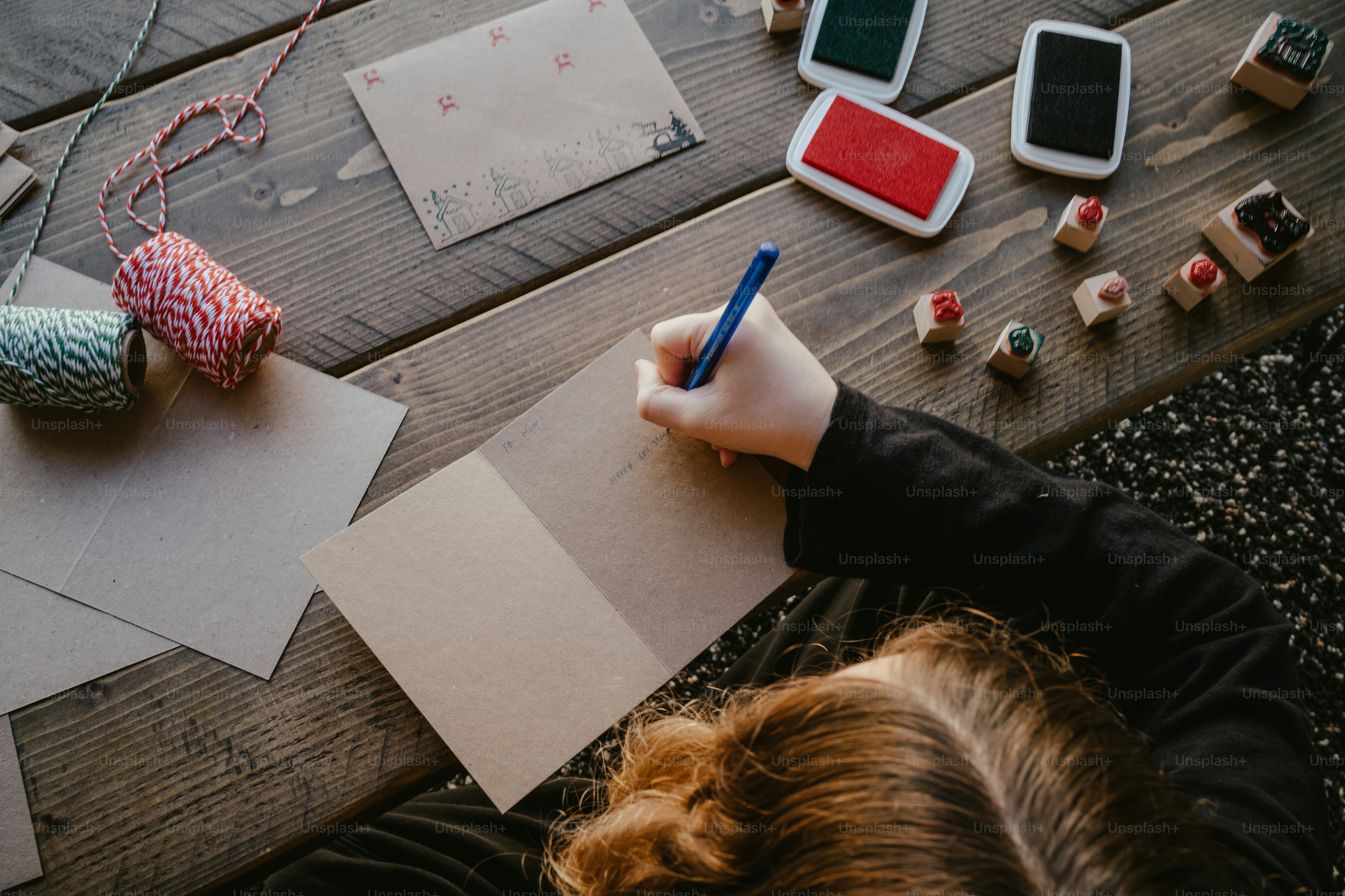 a person writing on a piece of paper