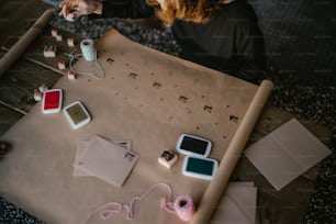 a woman sitting at a table working on crafts