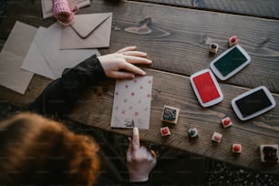 a person sitting at a table with some cards