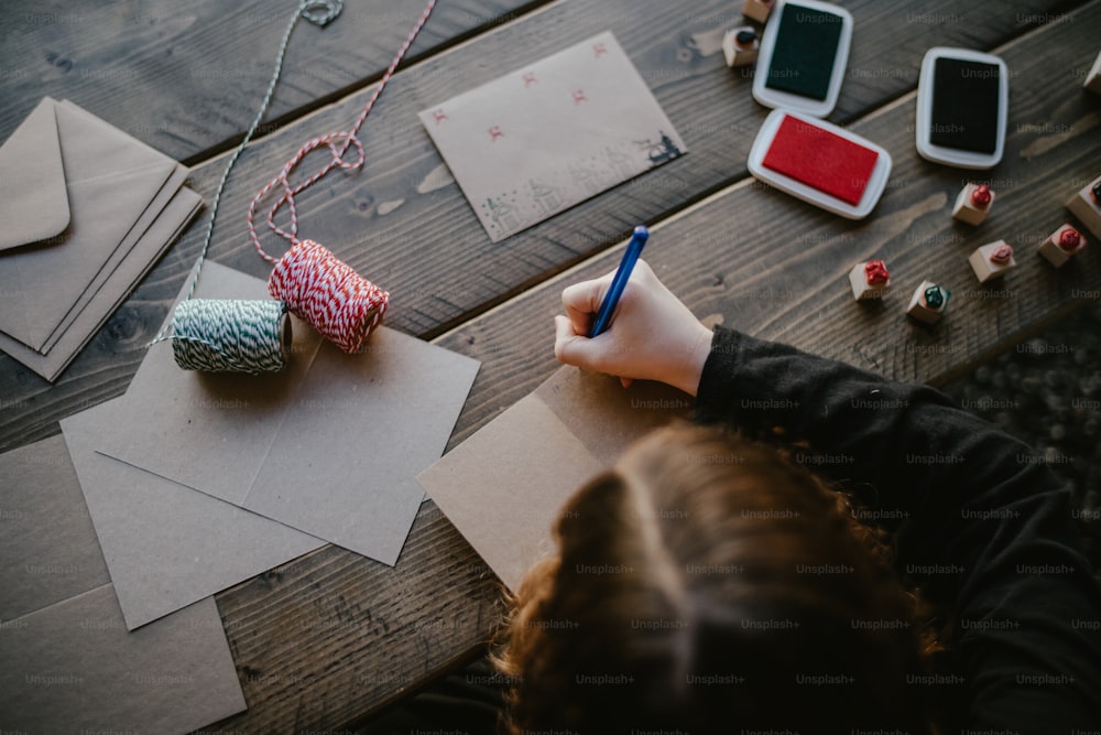 a person is writing on a piece of paper