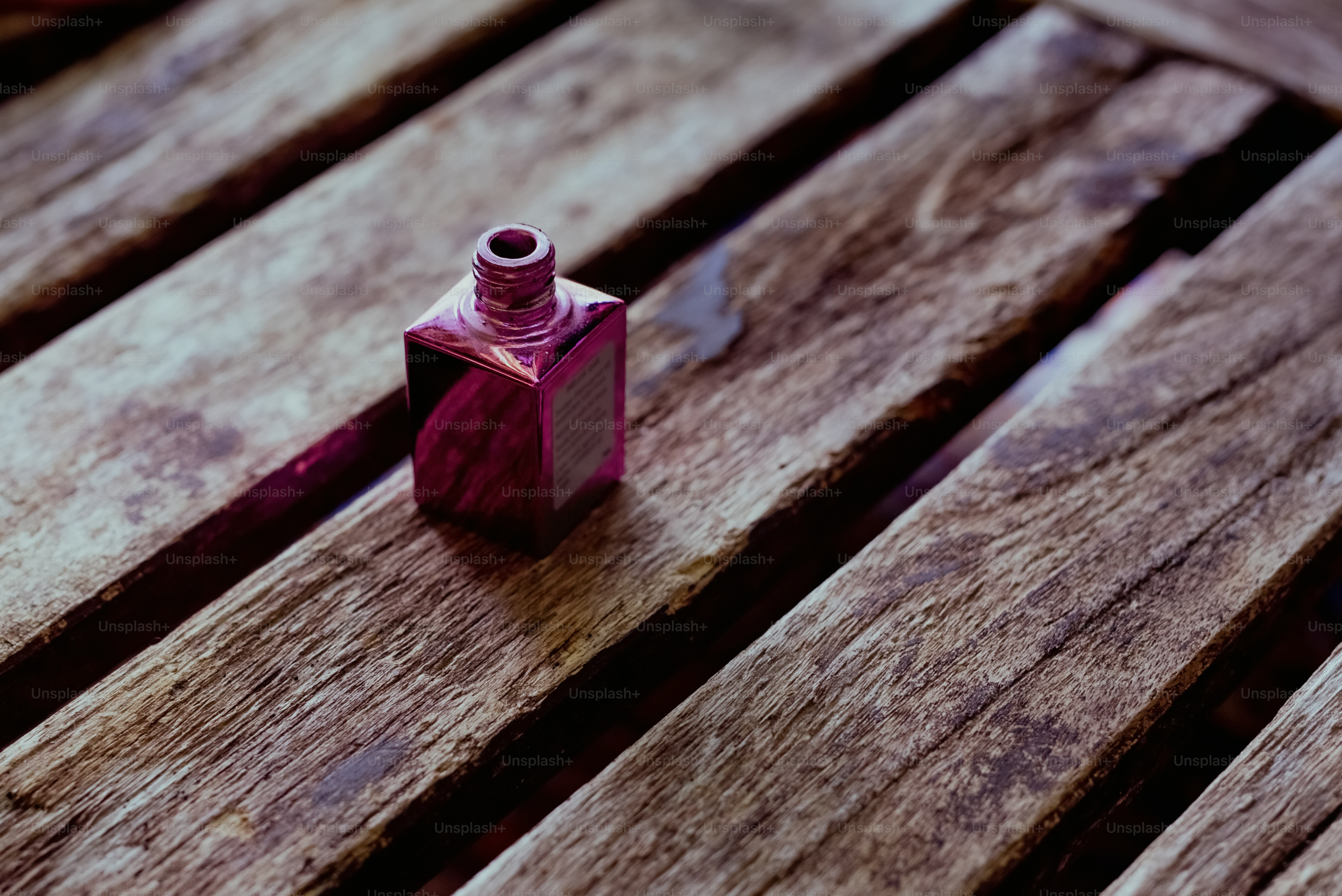 a wooden bench with a bottle on top of it