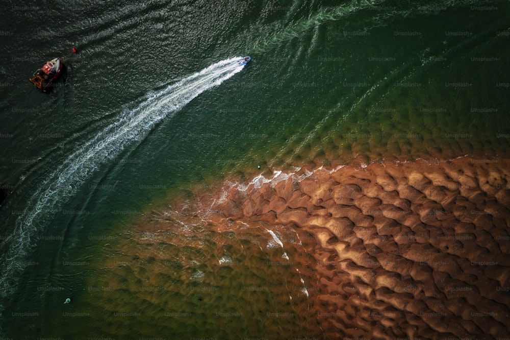 an aerial view of a boat in the water