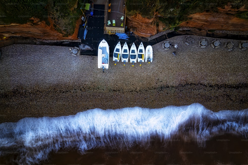 a group of surfboards sitting on top of a sandy beach