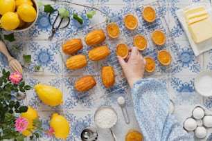 a person is decorating a table with oranges