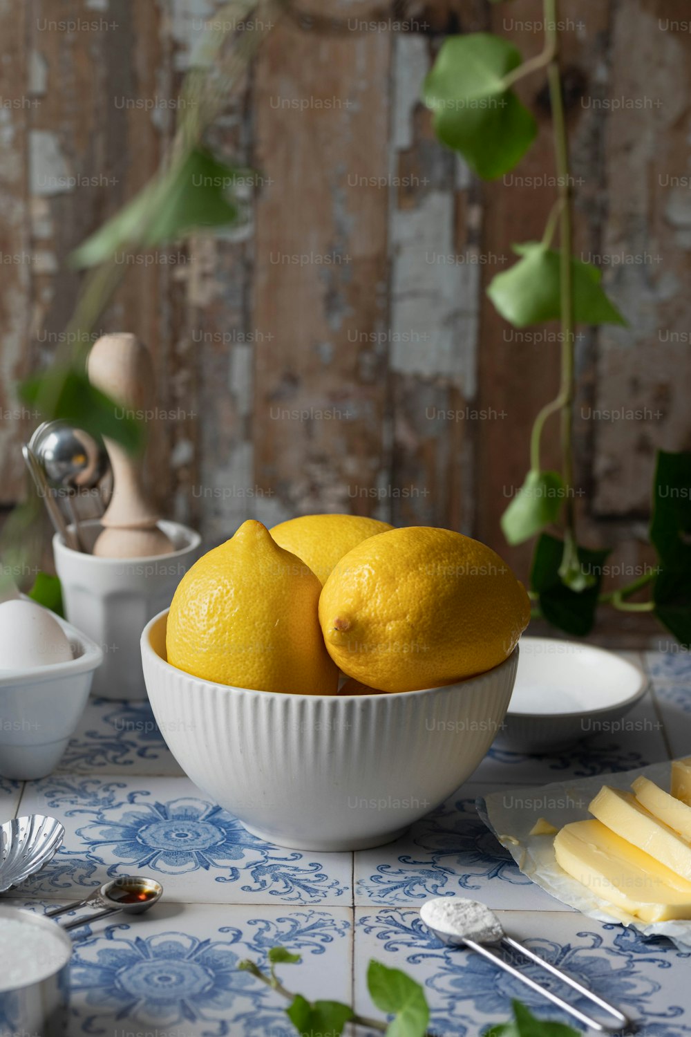 two lemons are in a bowl on a table