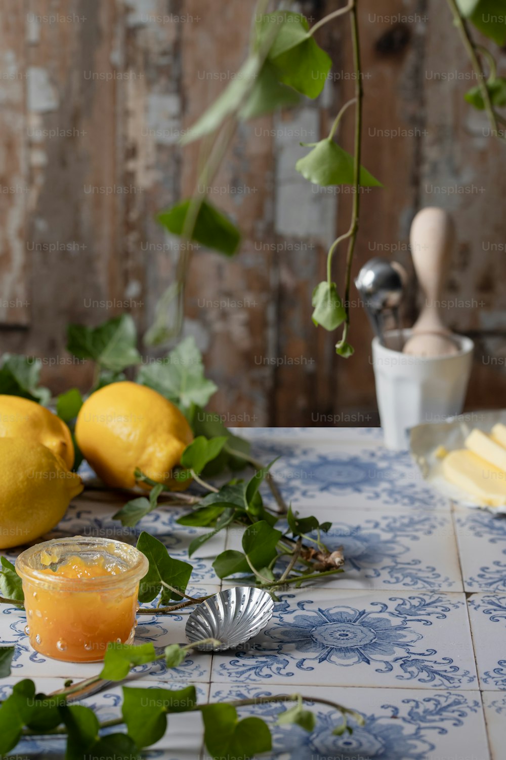 a table topped with lemons and a glass of orange juice