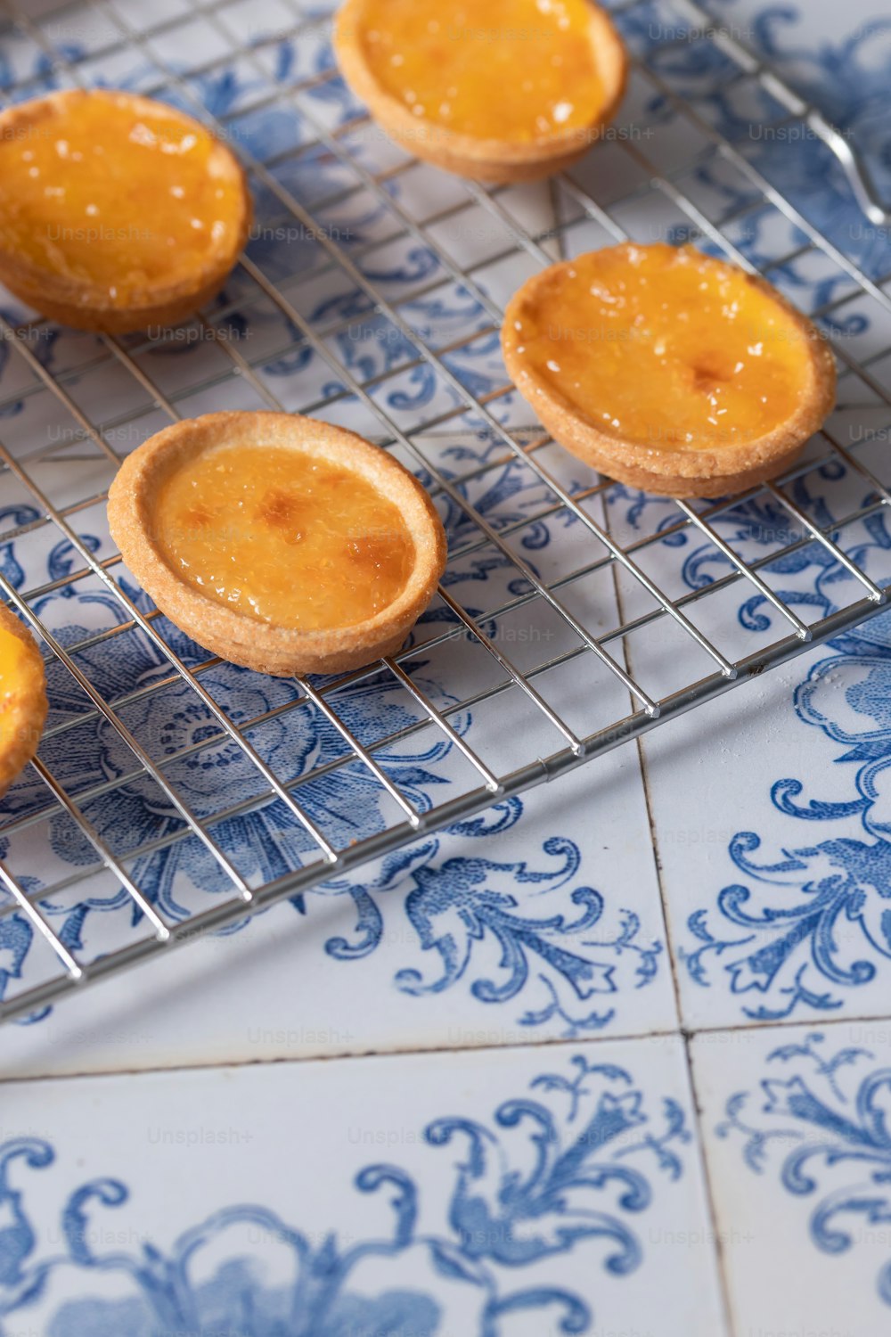 a cooling rack with several small pastries on it