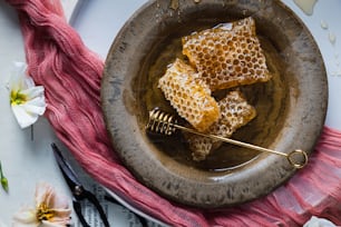 a bowl of honey with a comb in it