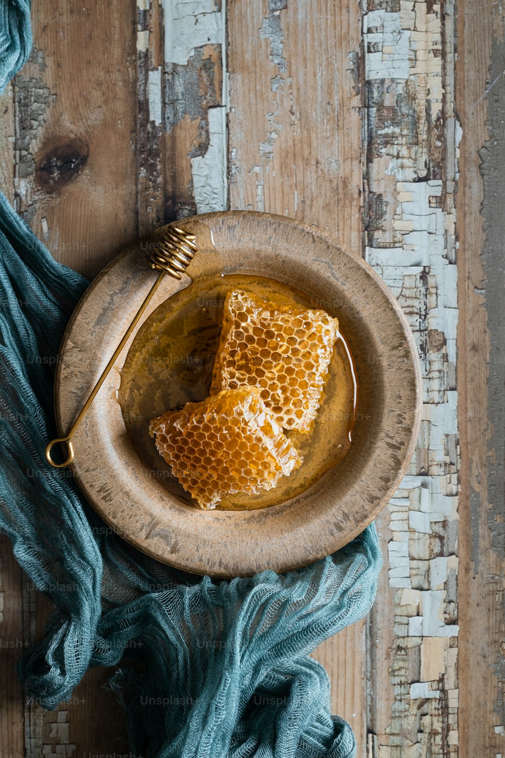a plate with a piece of honey on top of it