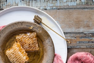two pieces of honey on a plate with a fork