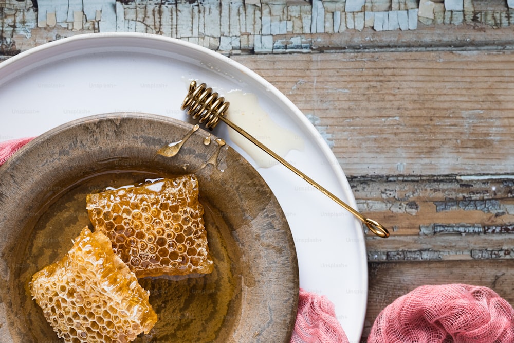 two pieces of honey on a plate with a fork