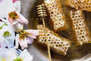 a plate of honey and flowers on a table