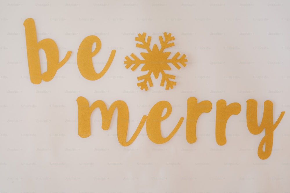 Un letrero que dice Be Merry with a Snowflake