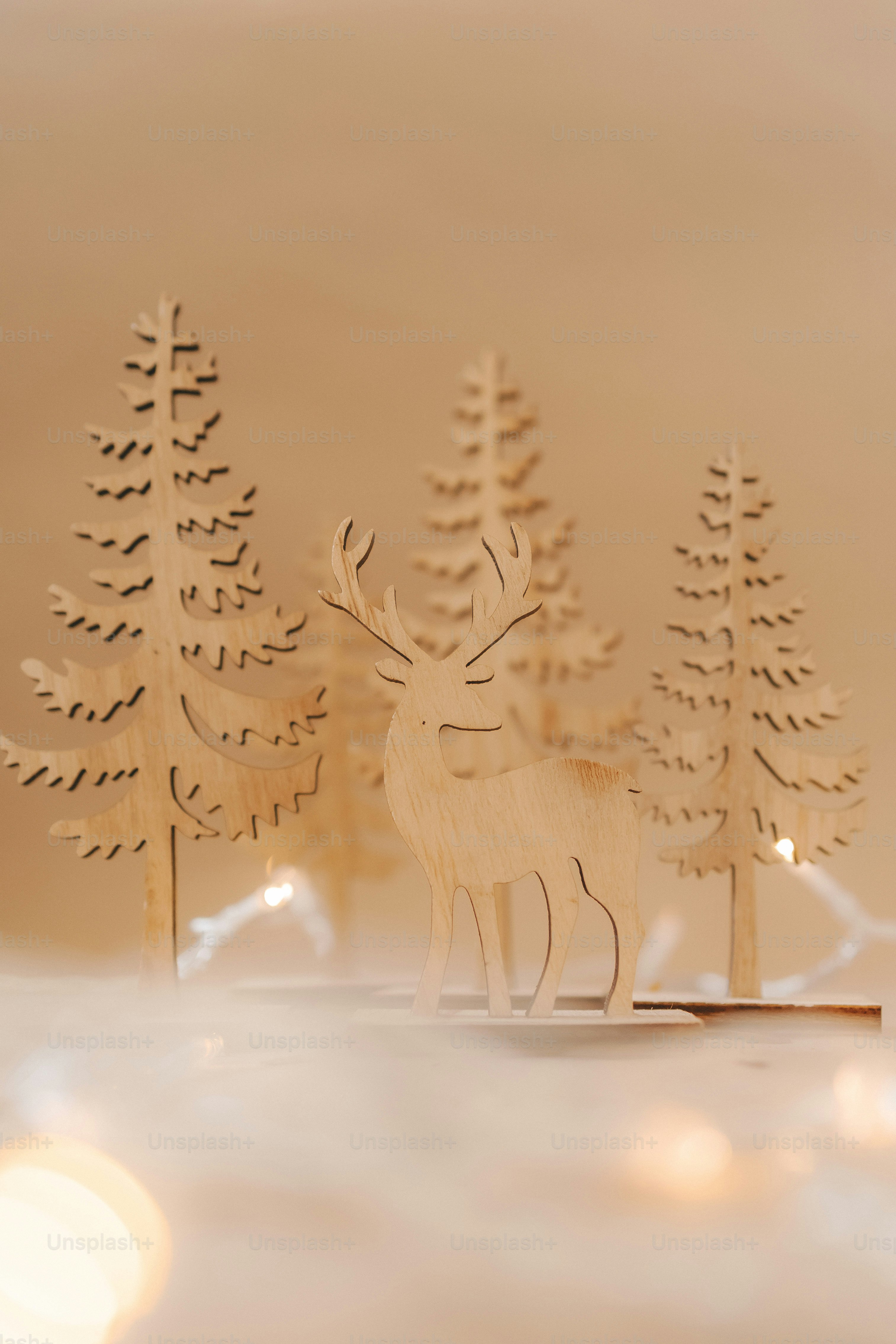 A paper cut of a deer standing in front of some trees photo – Christmas ...