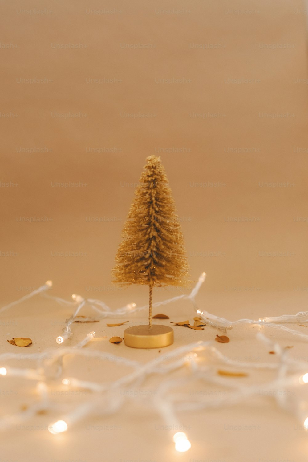 a small gold christmas tree sitting on top of a table