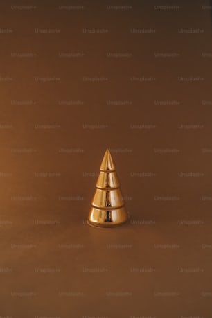 a gold christmas tree on a brown background