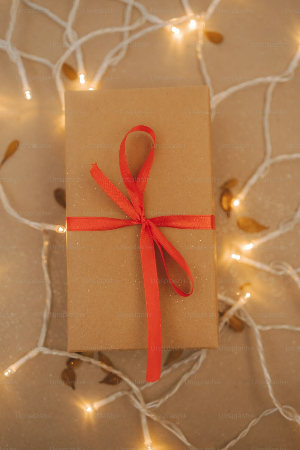 a brown box with a red ribbon tied around it