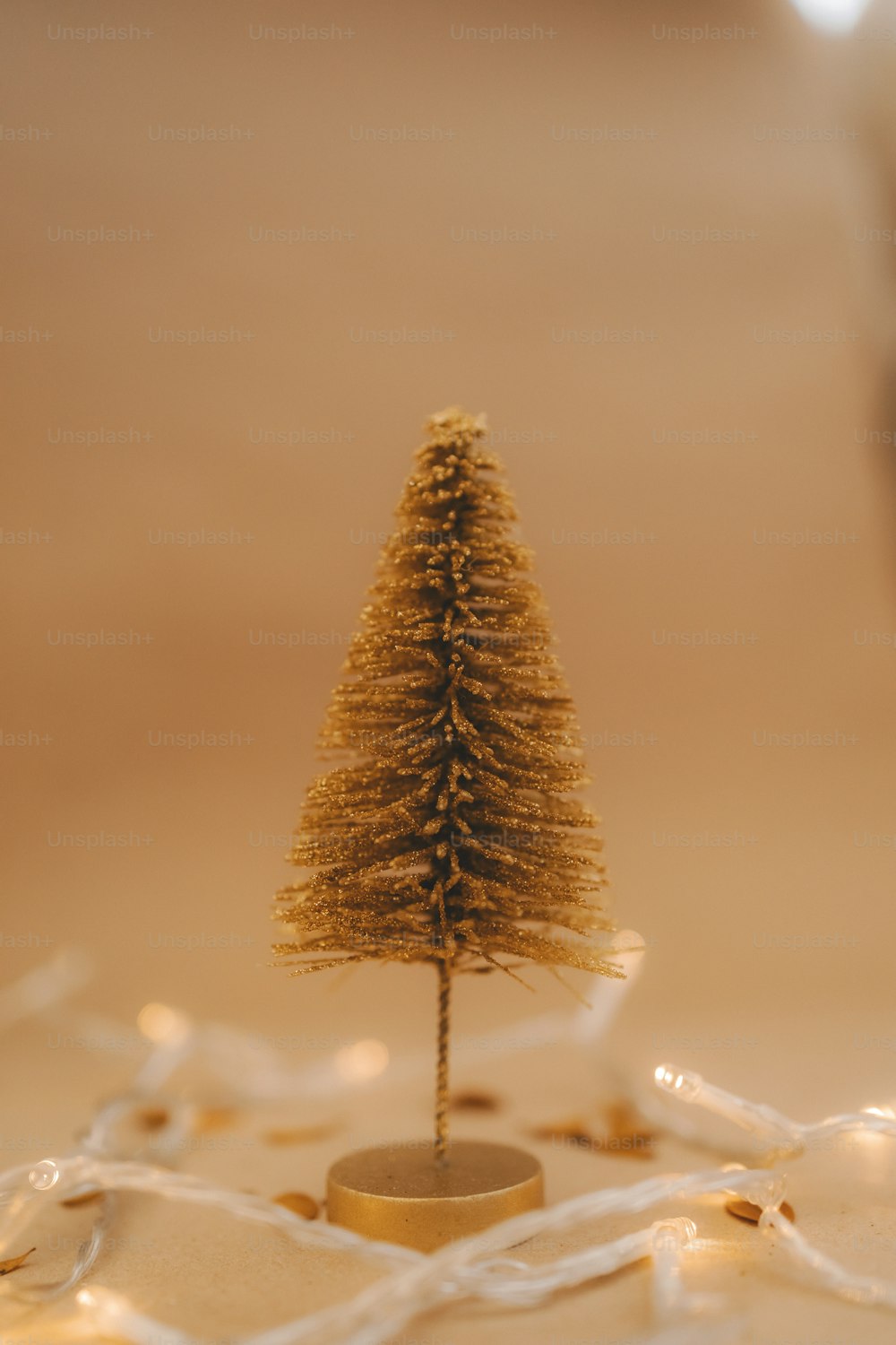 a small gold christmas tree sitting on top of a table