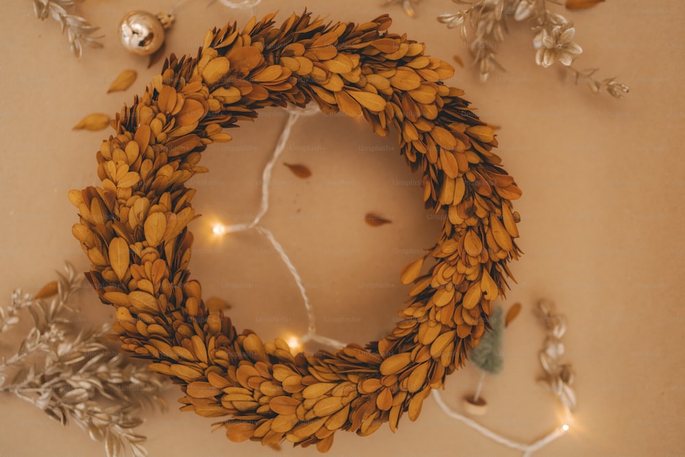 a christmas wreath with lights and ornaments around it