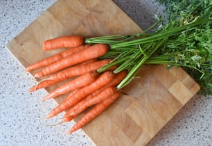 a bunch of carrots sitting on a cutting board