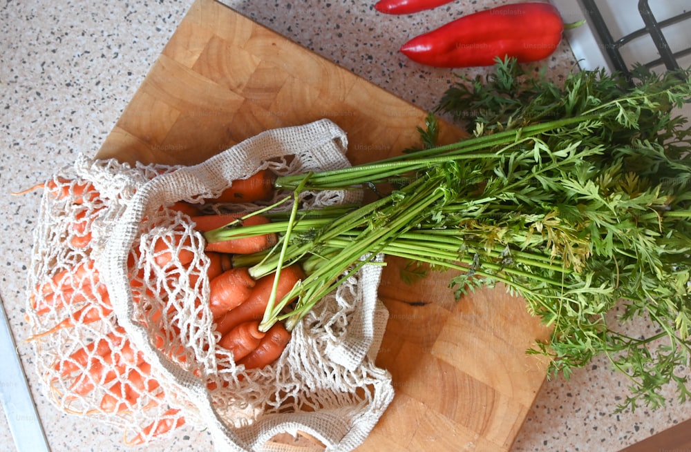 a bunch of carrots sitting on top of a wooden cutting board