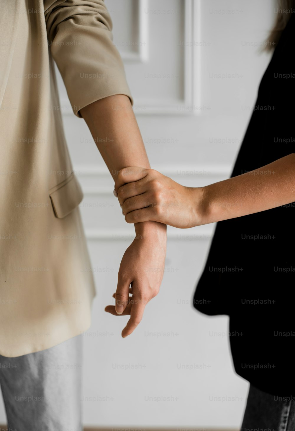 two people holding hands while standing next to each other