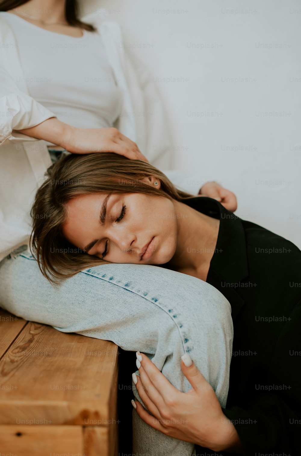 a woman laying on a bed with her head on a pillow