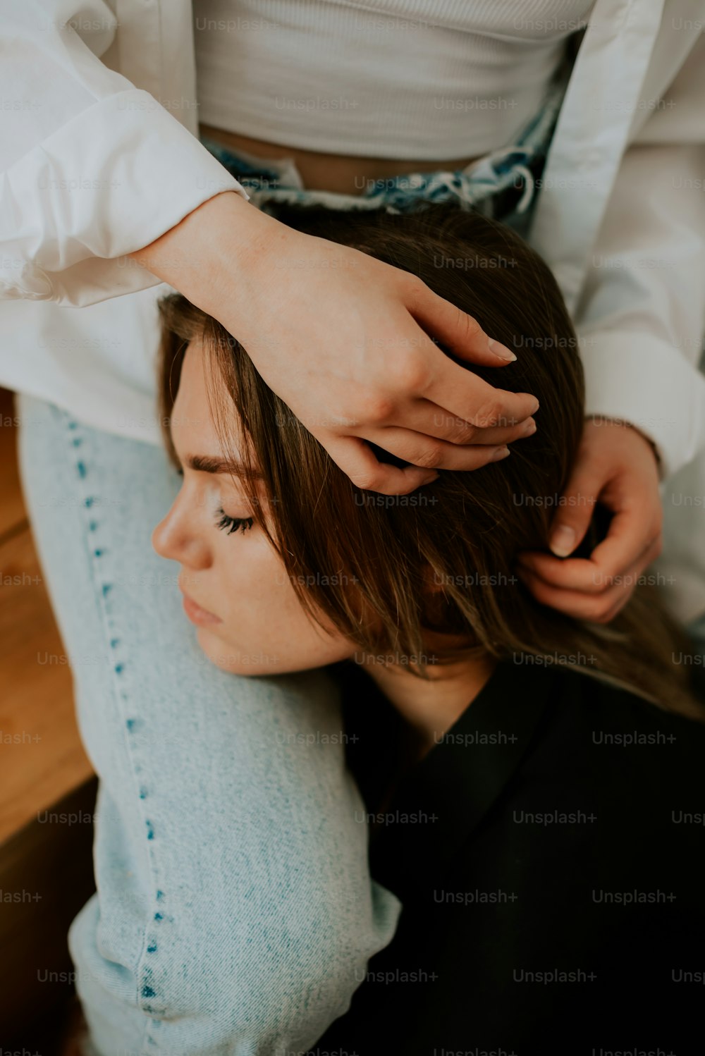 une femme se faisant coiffer par un coiffeur
