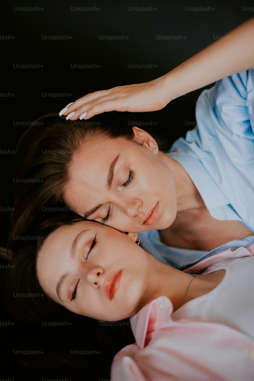 a woman and a girl laying on a bed together