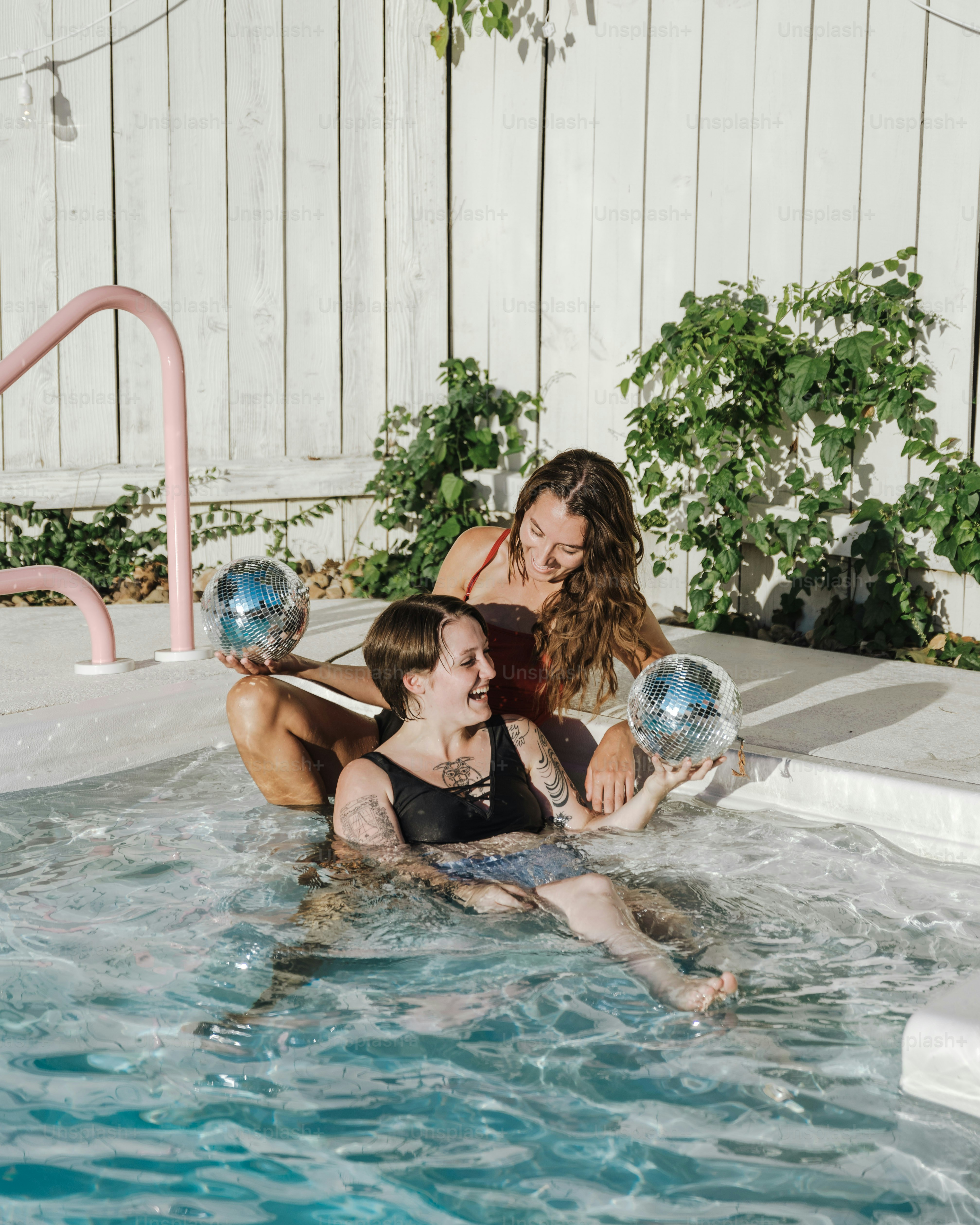 a woman and a girl in a swimming pool