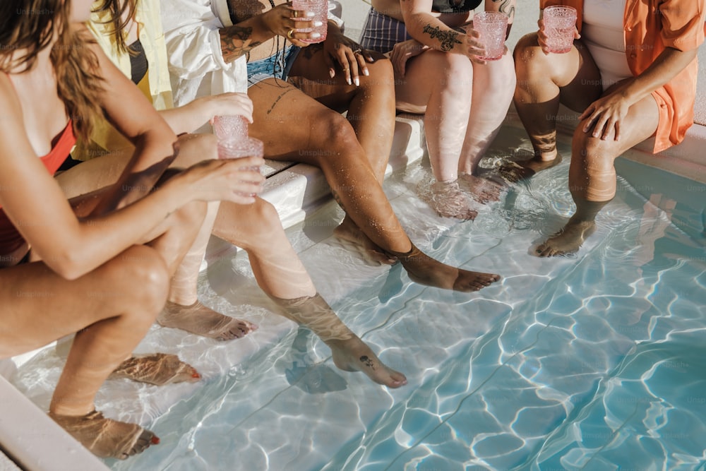 a group of people sitting in a swimming pool