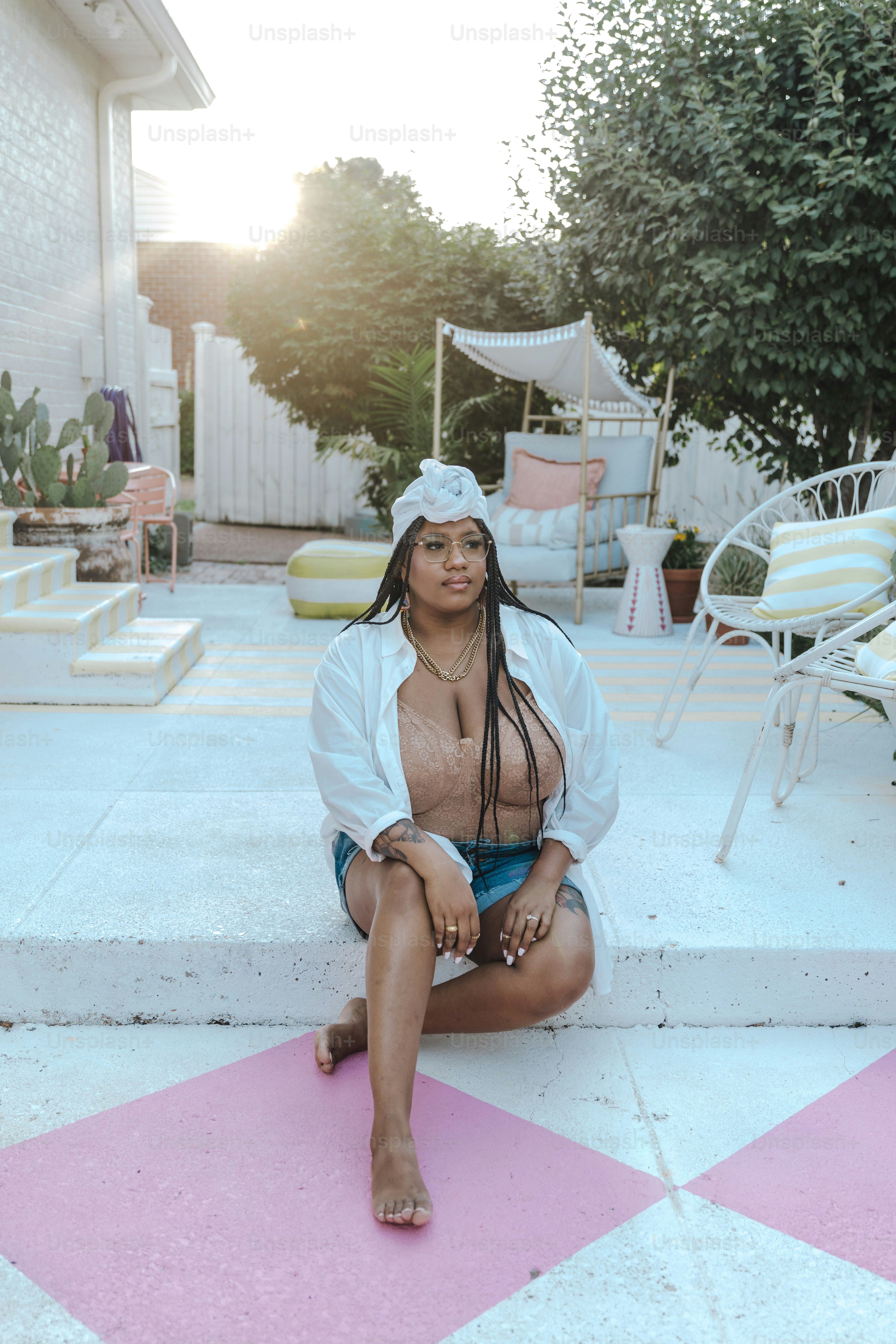 a woman sitting on a pink and white checkered floor