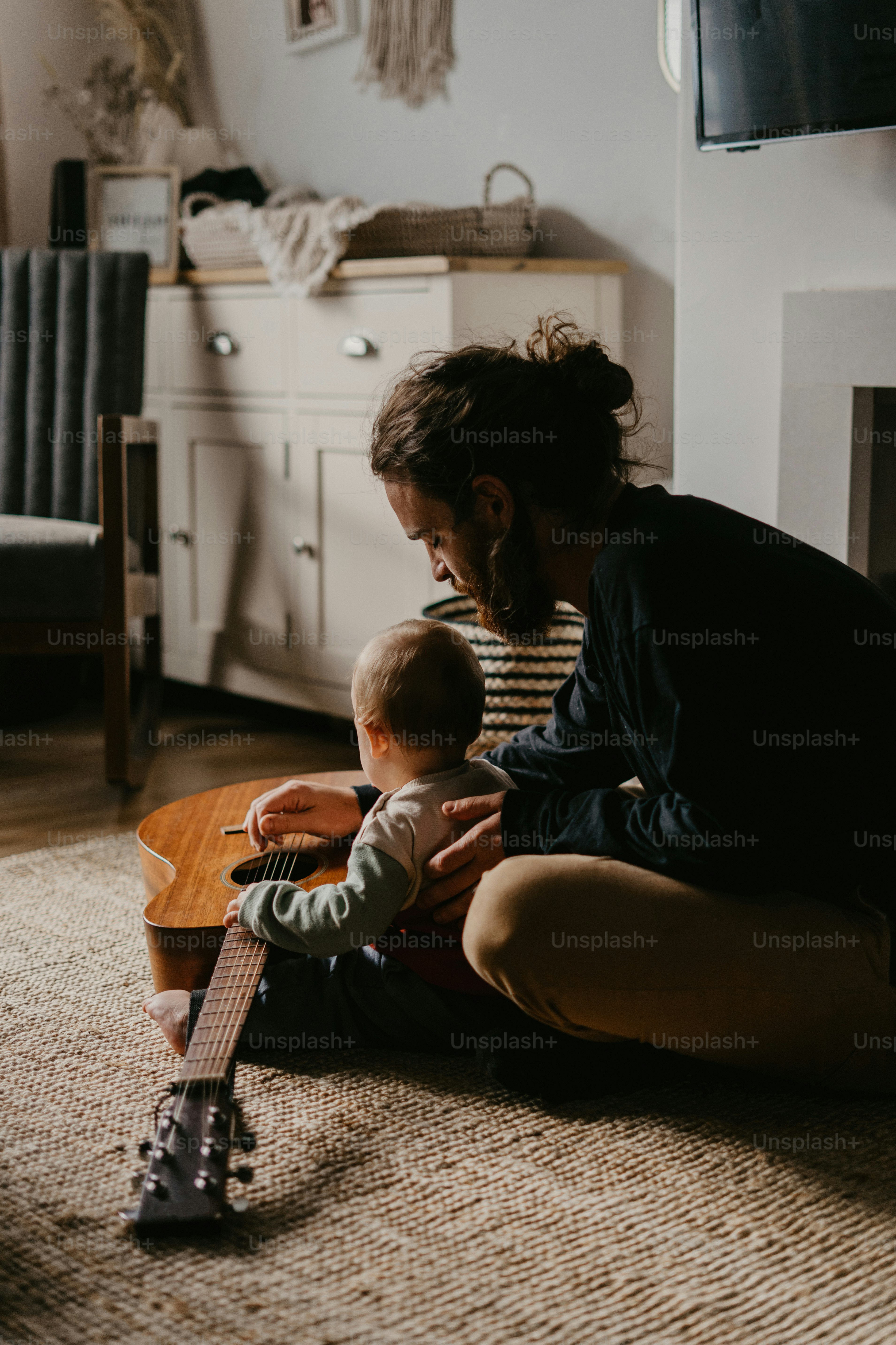 A woman playing with a baby while sitting on the floor photo – Parent ...