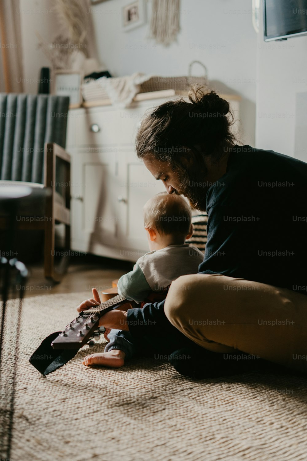 a woman sitting on the floor holding a baby