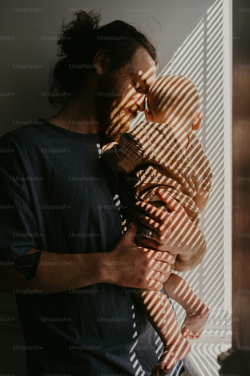 a man holding a baby in his arms