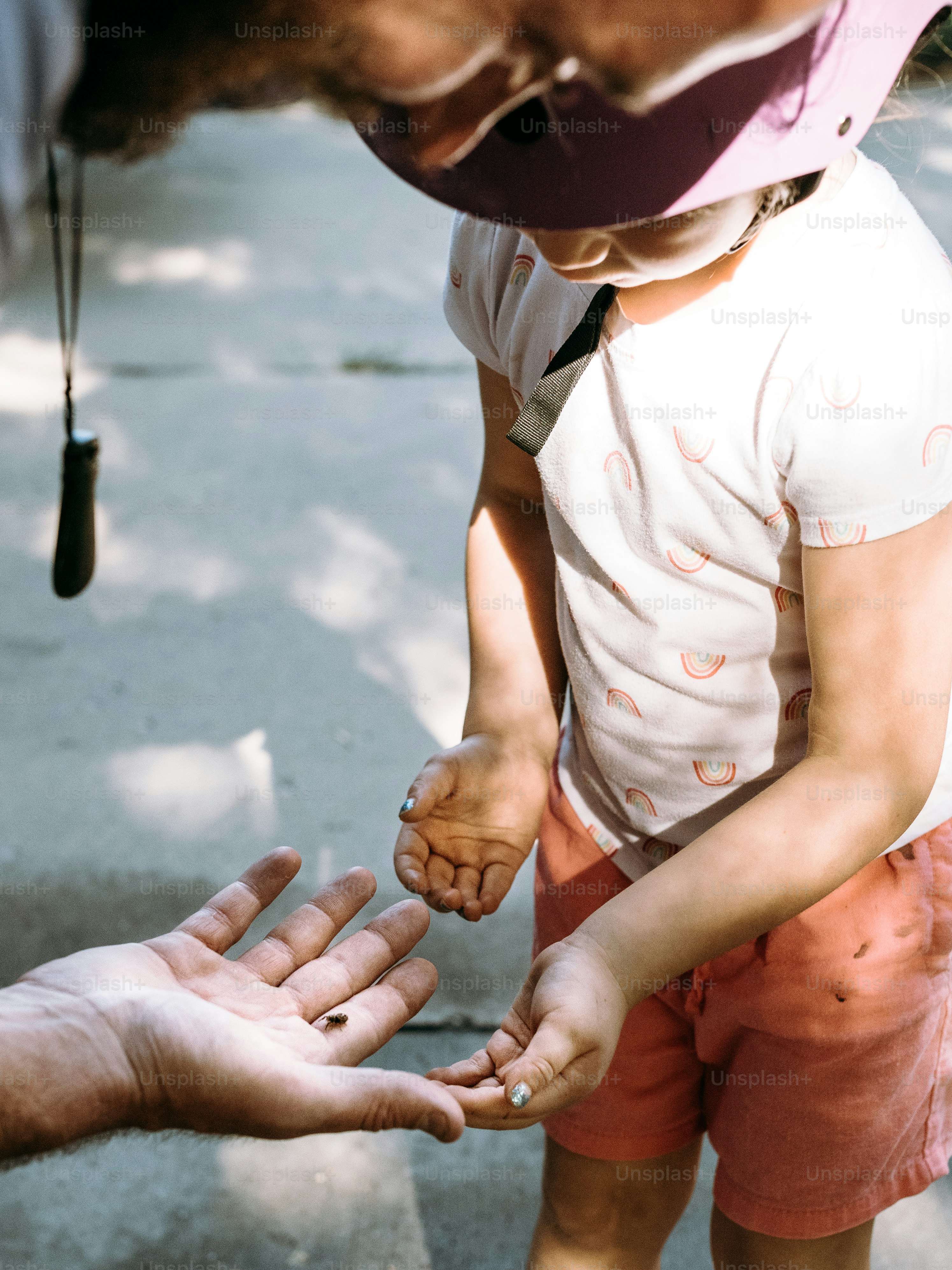 a little girl reaching out to a man's hand