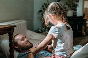 a man laying on a bed with a little girl