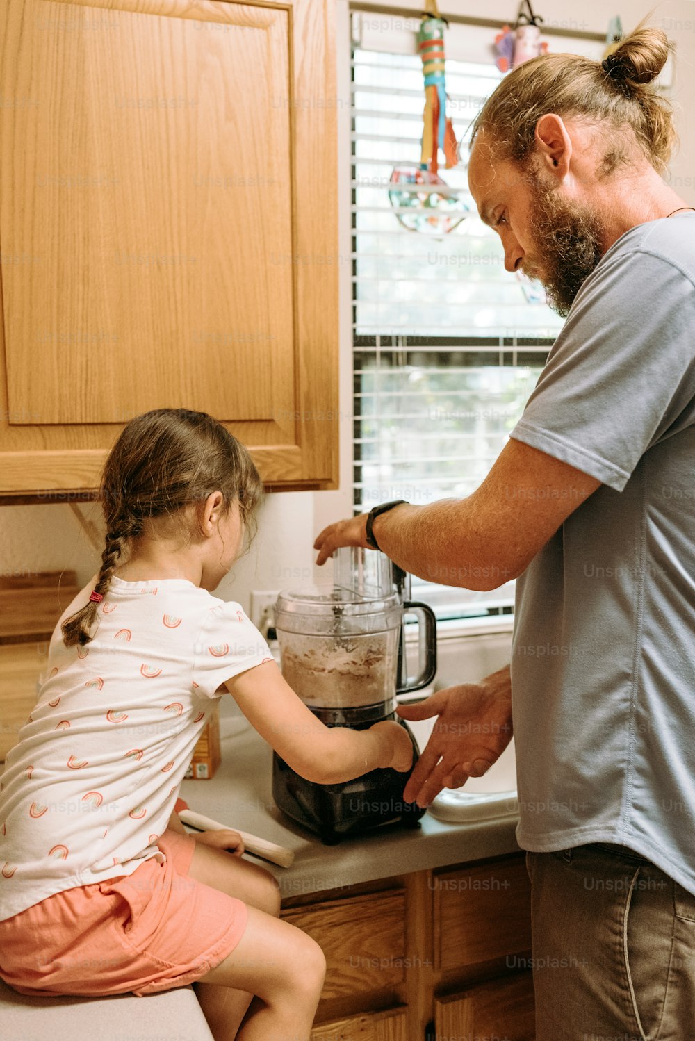 a man and a little girl in a kitchen