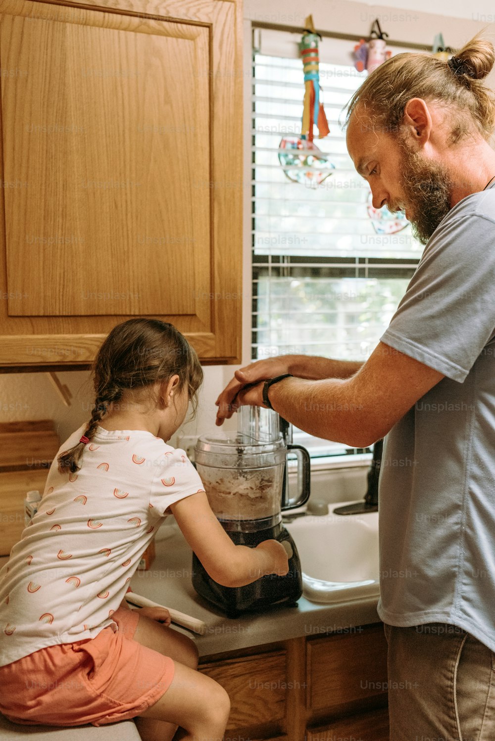 a man and a little girl in a kitchen