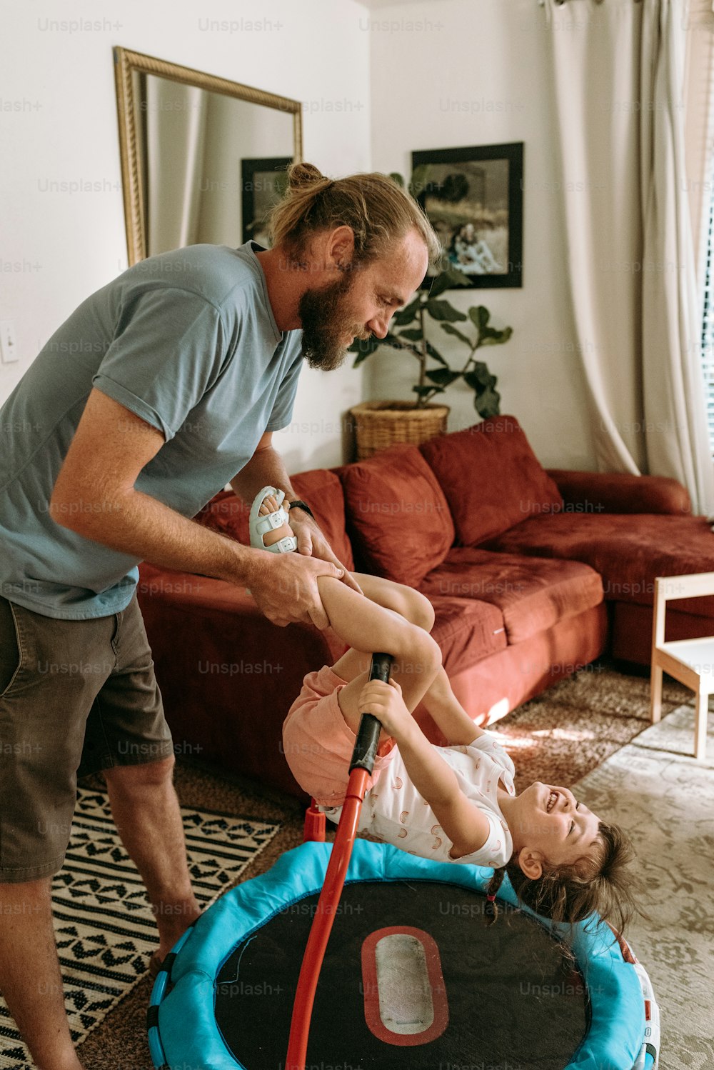 a man standing next to a little girl in a living room